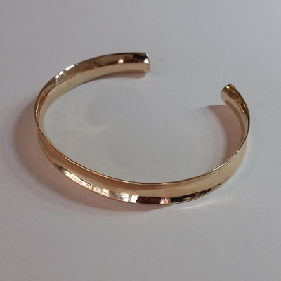 Plain simple anticlastic open bangle bracelet 14K red inherited gold recycled Daphne Meesters Jewellery Designer Goldsmith The Hague Netherlands