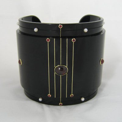 Alexandra's treasures wide cuff modern bracelet From Russia with love collection black plexiglass 14K yellow gold garnet pearl ruby € 1650,- Daphne Meesters Jewellery Designer Goldsmith The Hague Netherlands