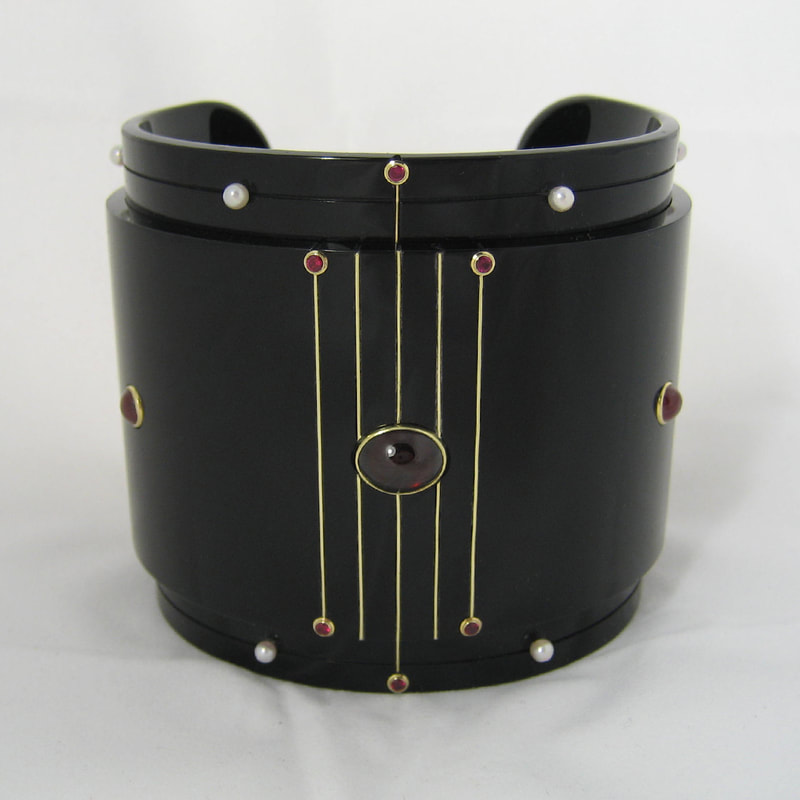 For sale Alexandra's treasures wide cuff modern bracelet From Russia with love collection black plexiglass 14K yellow gold garnet pearl ruby € 1650,- Daphne Meesters Jewellery Designer Goldsmith The Hague Netherlands