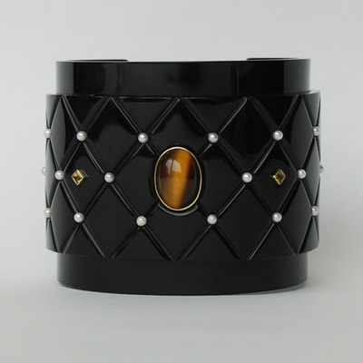 Faberges secret wide cuff bracelet From Russia with love collection quilted effect black plexiglass 14K yellow gold tigers eye pearl citrine amethyst unique piece € 1545,- Daphne Meesters Jewellery Designer Goldsmith The Hague Netherlands
