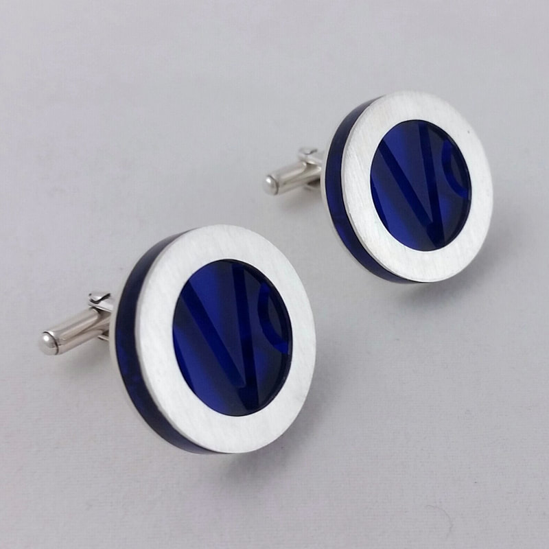 IVO cufflinks round sterling silver trim with initials in blue plexiglass 50th birthday gift Daphne Meesters Jewellery Designer Goldsmith The Hague Netherlands
