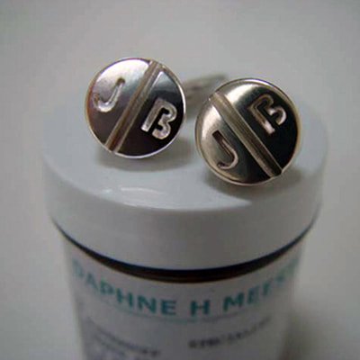 Pills cufflinks shiny finish sterling silver with initials pharmacy graduation gift close up Daphne Meesters Jewellery Designer Goldsmith The Hague Netherlands