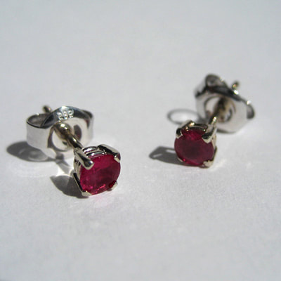 Ear studs 14K white gold claw setting round faceted rubies Daphne Meesters Jewellery Designer Goldsmith The Hague Netherlands