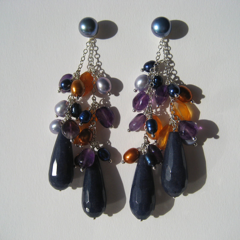 Dark blue pearl ear studs € 39,50 ear jackets from fine sterling silver chain dark blue jade faceted drops blue and orange pearls faceted carnelian beads 76 millimeters € 115,-  Daphne Meesters Jewellery Designer Goldsmith The Hague Netherlands
