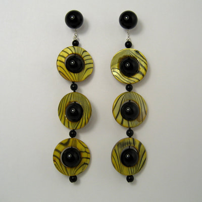 Large onyx ear studs and dangling yellow black ear jackets sterling silver onyx shell Daphne Meesters Jewellery Designer Goldsmith The Hague Netherlands
