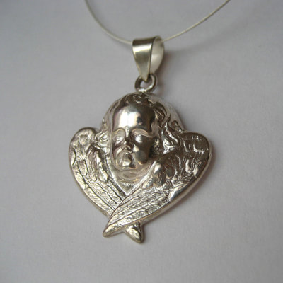 Angel in heaven antique silver angel mourning pendant filled with ashes of a loved one Daphne Meesters Jewellery Designer Goldsmith The Hague Netherlands

