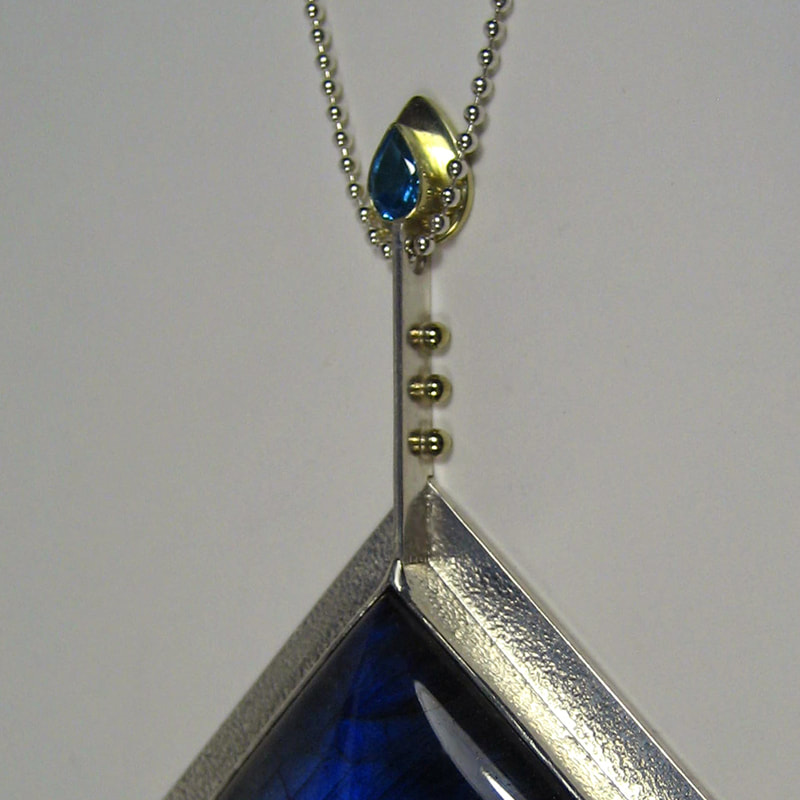 The sea of tears necklace Alice in wonderland exclusive collection square cabochon labradorite sterling silver modern pendant 14K yellow gold tears topaz unique piece 53 by 78 millimeters € 495,- Daphne Meesters Jewellery Designer Goldsmith The Hague Netherlands