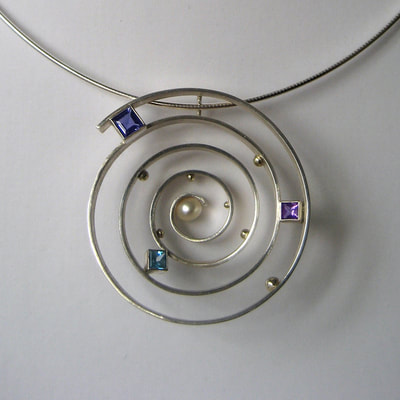 Deep down the rabbit hole pendant Alice in wonderland exclusive collection sterling silver open spiral with 14K gold balls iolite amethyst topaz faceted princess cut gemstones pearl unique piece € 535,- SOLD Daphne Meesters Jewellery Designer Goldsmith The Hague Netherlands