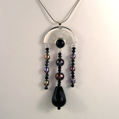 Art deco multi-jewel chandelier pendant 79 millimeters ear jackets 93 millimeters sterling silver arch with cabochon onyx dangling multi colour pearls faceted drop onyx unique piece € 245,- Daphne Meesters Jewellery Designer Goldsmith The Hague Netherlands