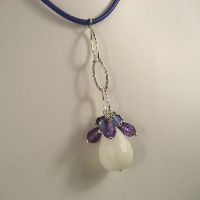 Pendant ear jacket multi-jewel sterling silver oval chain iolite amethyst and white agate faceted drop on blue leather string 67 millimeters € 62,50 Daphne Meesters Jewellery Designer Goldsmith The Hague Netherlands