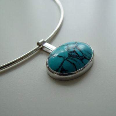 Signature oval reversible pendant sterling silver and oval cabochon turquoise with signature on the backside Daphne Meesters Jewellery Designer Goldsmith The Hague Netherlands
