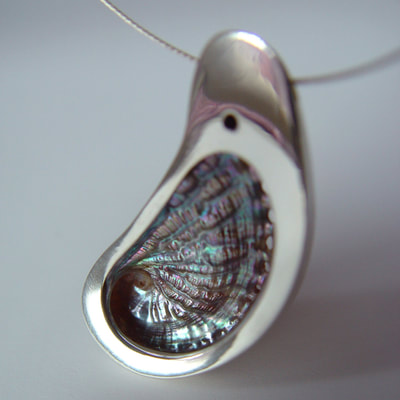 Conchiglia pendant sterling silver organic shape with shiny finish and abalone shell from Sicily Daphne Meesters Jewellery Designer Goldsmith The Hague Netherlands