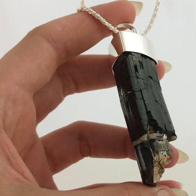 Tourmaline pendant shiny finish sterling silver and rough black tourmaline crystal on sterling silver rope necklace Daphne Meesters Jewellery Designer Goldsmith The Hague Netherlands