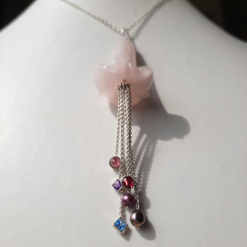 The talking flowers pendant Alice in wonderland exclusive collection flower shaped rose quartz sterling silver chain cabochon red garnet rhodolite and faceted gemstones purple amethyst blue topaz € 195,- Daphne Meesters Jewellery Designer Goldsmith The Hague Netherlands