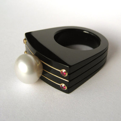The last Tsar modern statement ring From Russia with love collection black plexiglass 14K yellow gold white pearl red ruby size 18.25 millimeters unique piece € 780,- Daphne Meesters Jewellery Designer Goldsmith The Hague Netherlands
