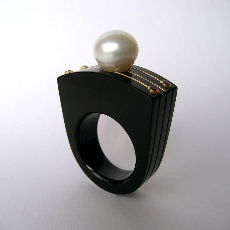 The last Tsar modern statement ring From Russia with love collection black plexiglass 14K yellow gold white pearl red ruby size 18.25 millimeters unique piece € 780,- Daphne Meesters Jewellery Designer Goldsmith The Hague Netherlands