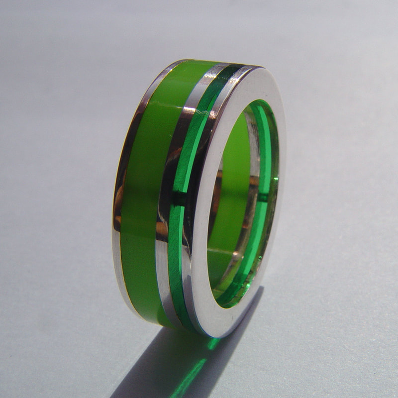 Layers of green ring sterling silver bright green plexiglass and lines contemporary flat surface size 19 millimeters € 215,- Daphne Meesters Jewellery Designer Goldsmith The Hague Netherlands
