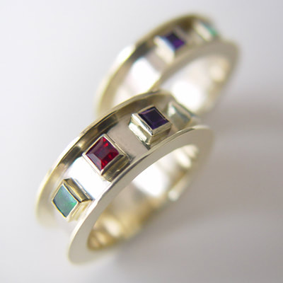 Medieval wedding bands rings contemporary wide flat high border 14K white yellow gold birthstones ruby emerald amethyst high polished handwriting engraving Daphne Meesters Jewellery Designer Goldsmith The Hague Netherlands