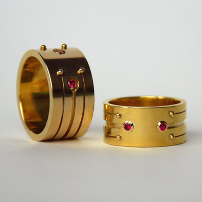 Soyuz 1 & 2 wedding bands rings From Russia with love collection modern wide layered lines 14K yellow gold rubies Daphne Meesters Jewellery Designer Goldsmith The Hague Netherlands